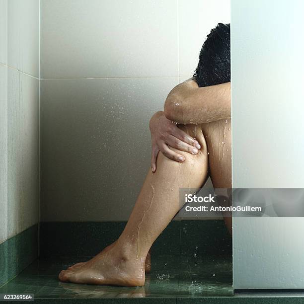 Sad Woman After Abuse In Shower Stock Photo - Download Image Now - Sexual Assault, Pain, Shower