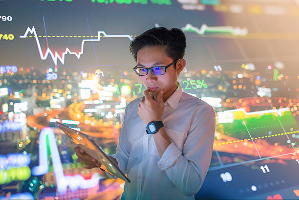 istock Young Businessman using a tablet analysis stockmarket for investment 623271506