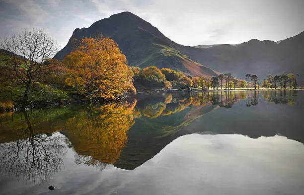 Misty autumn reflection and colours at Buttermere Lake