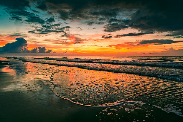 Dramatic colors of the sun barely above the horizon.