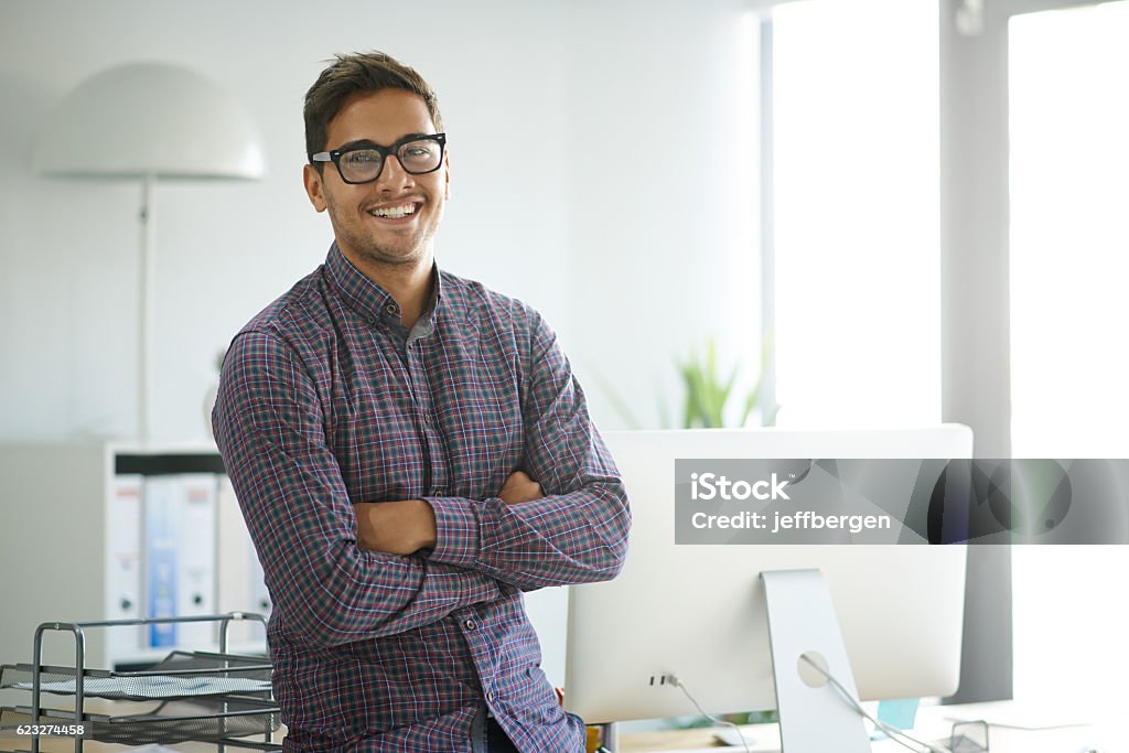 Creative confidence Portrait of a handsome young designer standing with his arms folded in the office Young Adult Stock Photo