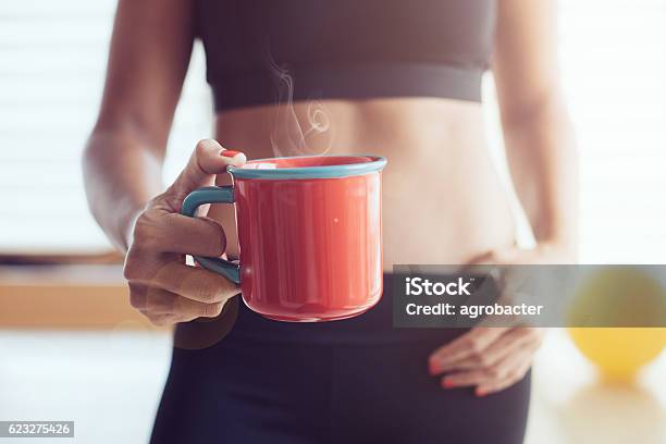 Athletic Young Woman With Cup Stock Photo - Download Image Now - Coffee - Drink, Dieting, Exercising