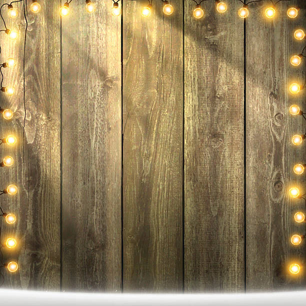 istock Christmas Lights on lit blank wooden background with snow 623277886