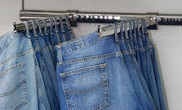 istock Row of hanged blue jeans in a shop 623279964