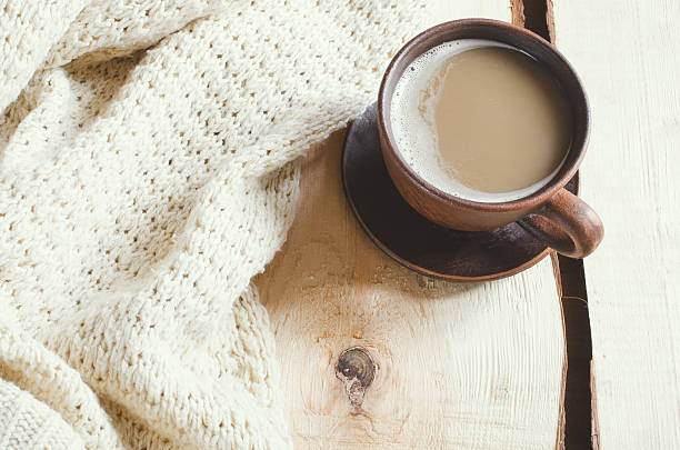 istock Soft white knitted sweater and cup of hot cocoa. 623280192