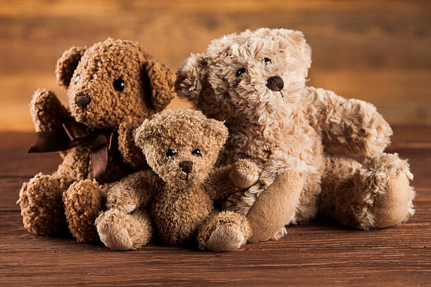 istock Cute teddy bears on wooden background 623280676