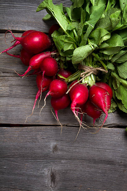 istock Fresh home grown radishes on old wooden boards 623281090