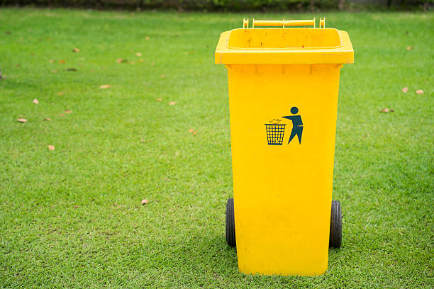 istock close up of yellow bins in public park 623285154