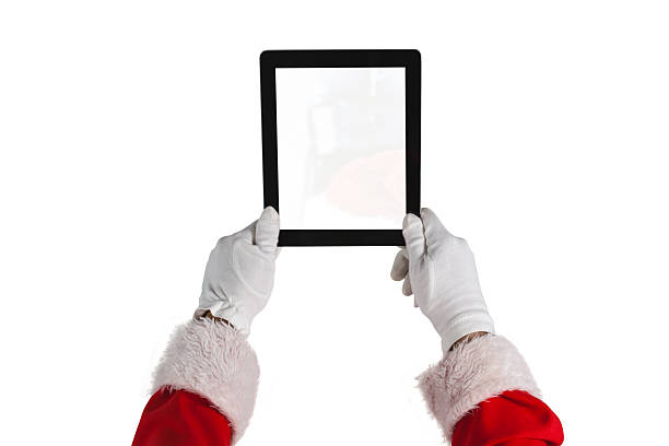 istock Santa claus holding digital tablet against white background 623286318