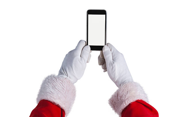 istock Santa claus holding mobile phone against white background 623286390