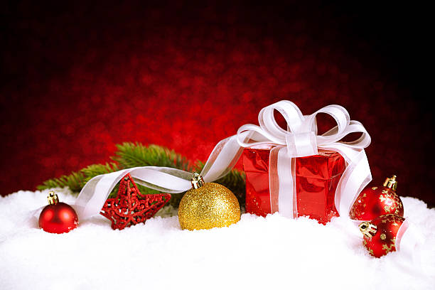 istock Christmas gift box with balls, stars and decoration on snow 623287098
