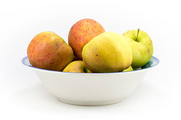 istock Colorful windfall apples in a bowl on a white background. 623289336