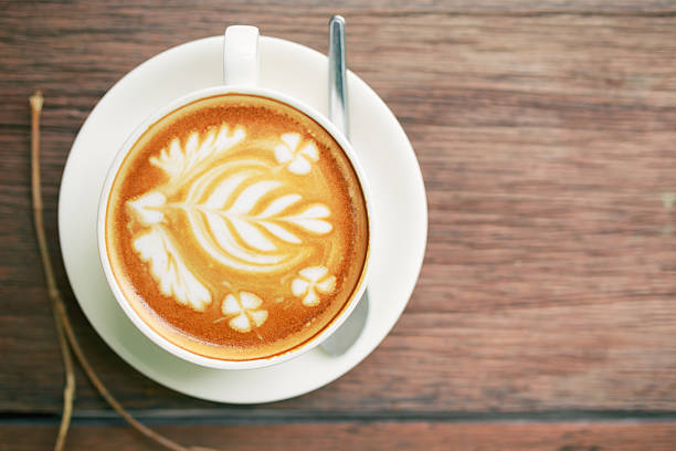 istock Coffee latte art cup top view on wood table background 623289538