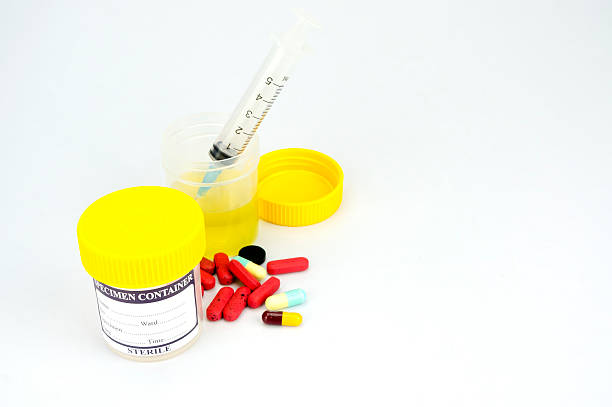 istock Urine sample bottle, syringe and pills isolated 623290582