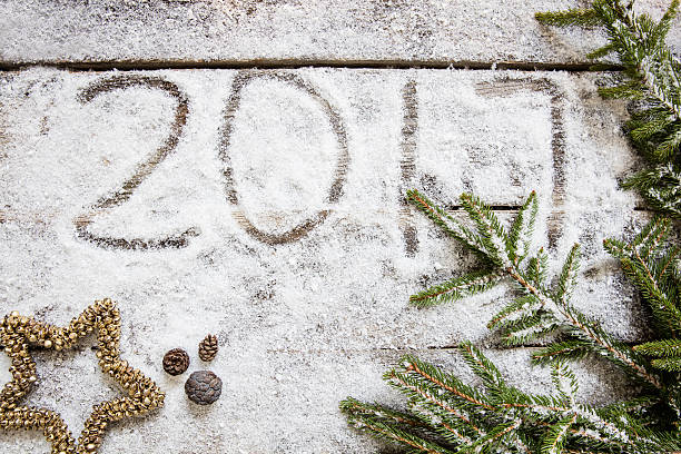 istock Announcing 2017 on winter snow background for holiday, top view 623290964