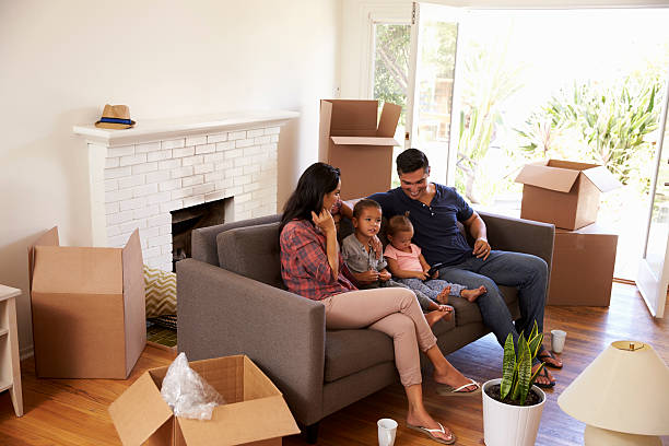 istock Family On Sofa Taking A Break From Unpacking Watching TV 623294230
