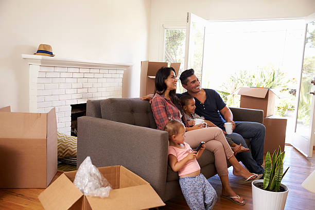 istock Family On Sofa Taking A Break From Unpacking Watching TV 623294272