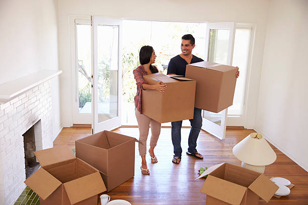 istock Couple Carrying Boxes Into New Home On Moving Day 623294372