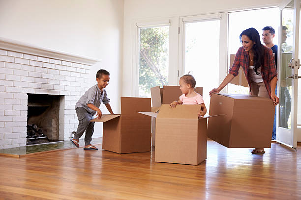 istock Family Unpacking Boxes In New Home On Moving Day 623294496