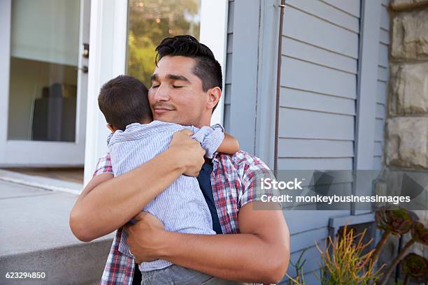 Father Hugging Son Sitting On Steps Outside Home Stock Photo - Download Image Now - Latin American and Hispanic Ethnicity, Family, Father