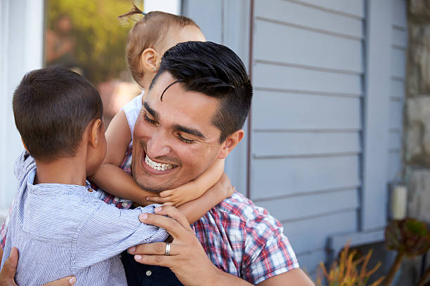 istock Father With Children Sitting On Steps Outside Home 623294866