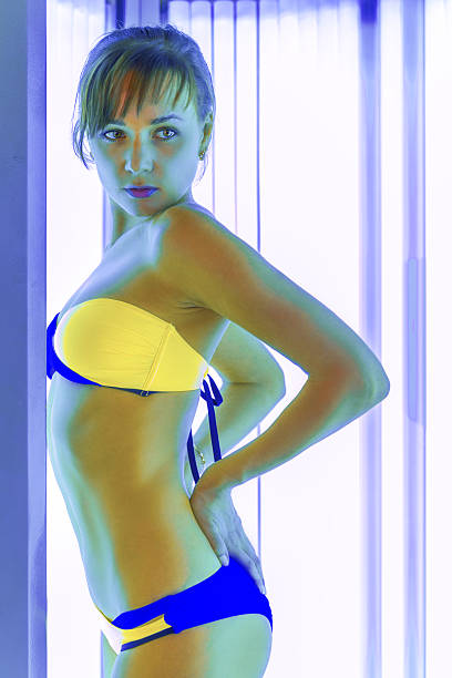 istock Slim woman in solarium getting sun tan 623294954