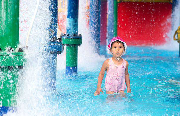 little girl  afraid of water in aqua park - unwillingness imagens e fotografias de stock