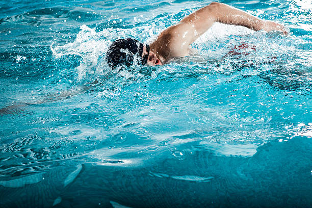 istock Young man swimming the front crawl in a pool 623296172