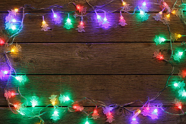istock christmas lights border on wood background 623296880