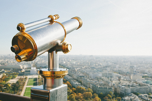 Telescope overlooking beautiful city of Paris 