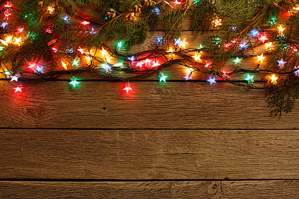istock christmas lights border on wood background 623297576