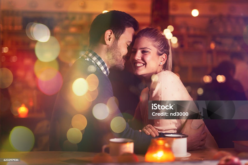 Romantic couple dating in pub Romantic couple dating in pub at night Flirting Stock Photo