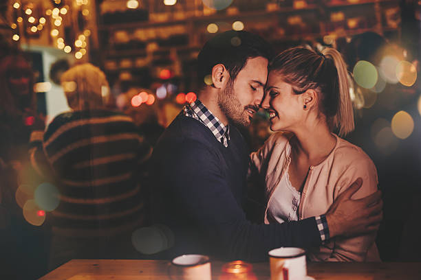 istock Couple dating at night in pub 623298352