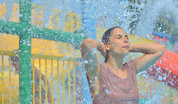 istock Beautiful woman enjoying under a water jet 623298374