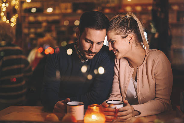 istock Couple dating at night in pub 623298536