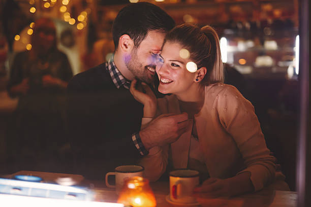istock Couple dating at night in pub 623298704
