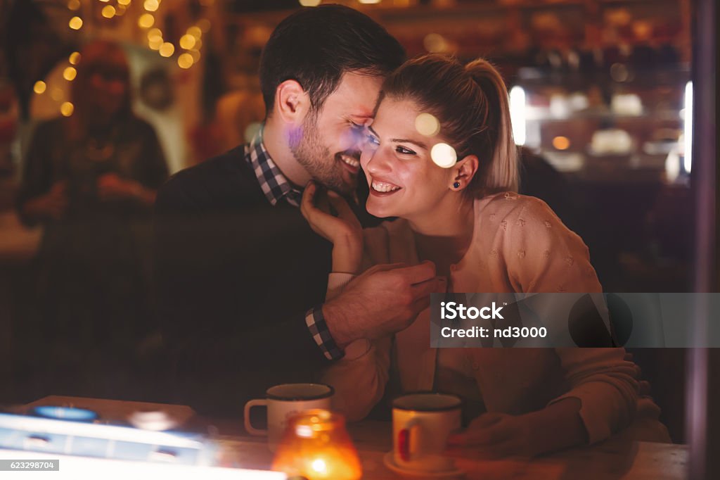 Couple dating at night in pub Romantic couple dating at night in pub Couple - Relationship Stock Photo