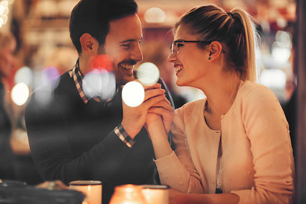 istock Couple dating at night in pub 623298798