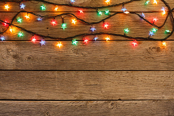 istock christmas lights border on wood background 623298896