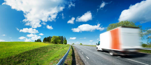 istock asphalt road on dandelion field 623302560