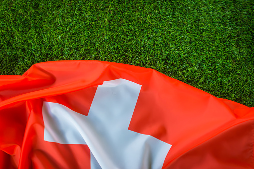 Swiss flag on green grass