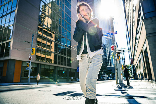 Young woman talking on mobile in downtown Toronto, Canada.