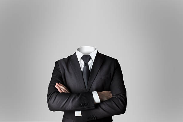 businessman without head crossed arms dark grey background