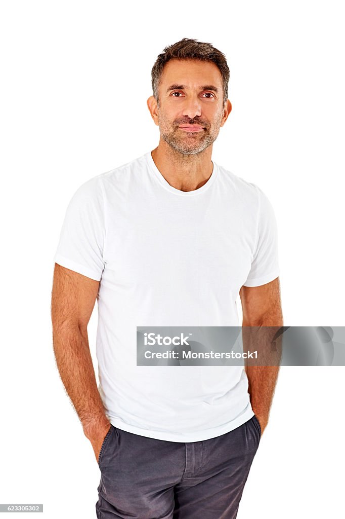 Confident mature man standing on white background Portrait of confident mature man standing with his hands in pocket on white background Men Stock Photo