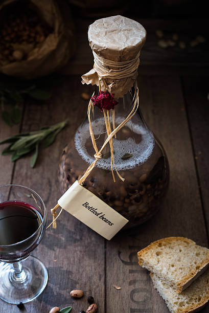eye beans cooked in a bottle Italian food: eye beans cooked in bottle, rustic bread and glass of wine lavagna stock pictures, royalty-free photos & images