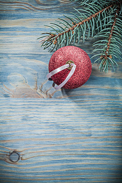 istock Fir branch red shining bauble on wooden board celebrations conce 623306404