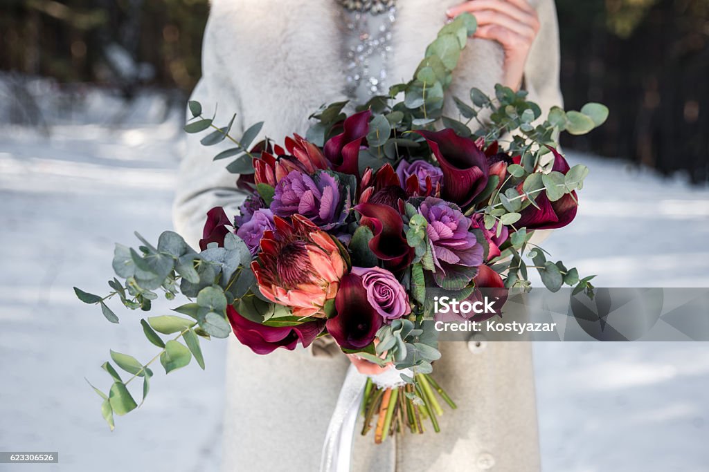 Wedding bouquet in hands of the bride Wedding bouquet in hands of the bride. Winter time, snowy fores Wedding Stock Photo