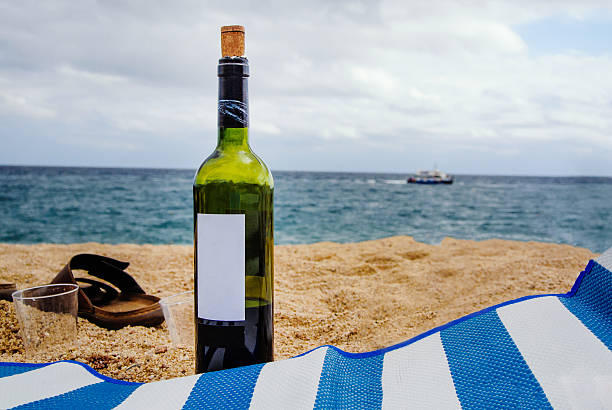 Bottle of wine in sand on the beach, during the holidays