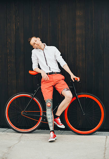 istock Hipster with bycicle and tatoo at dark background 623343454