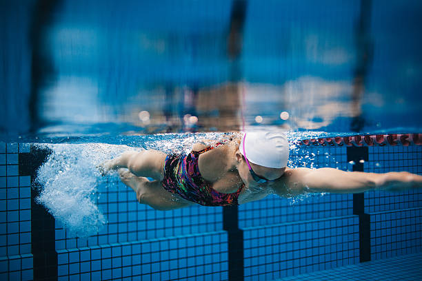 istock Female swimmer in action inside swimming pool. 623344218